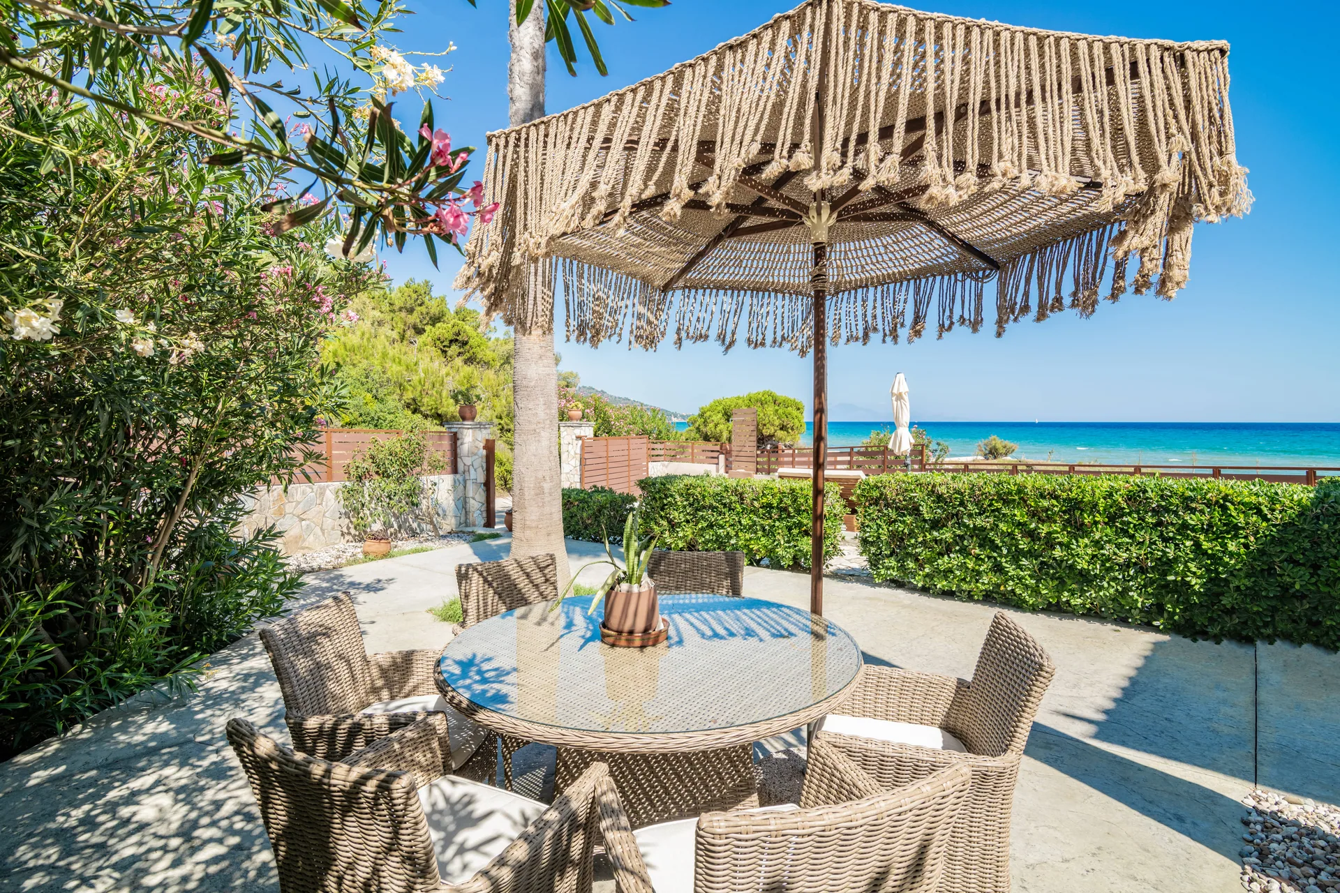 Sunlit terrace overlooking the sea at Royal Seaview Villa